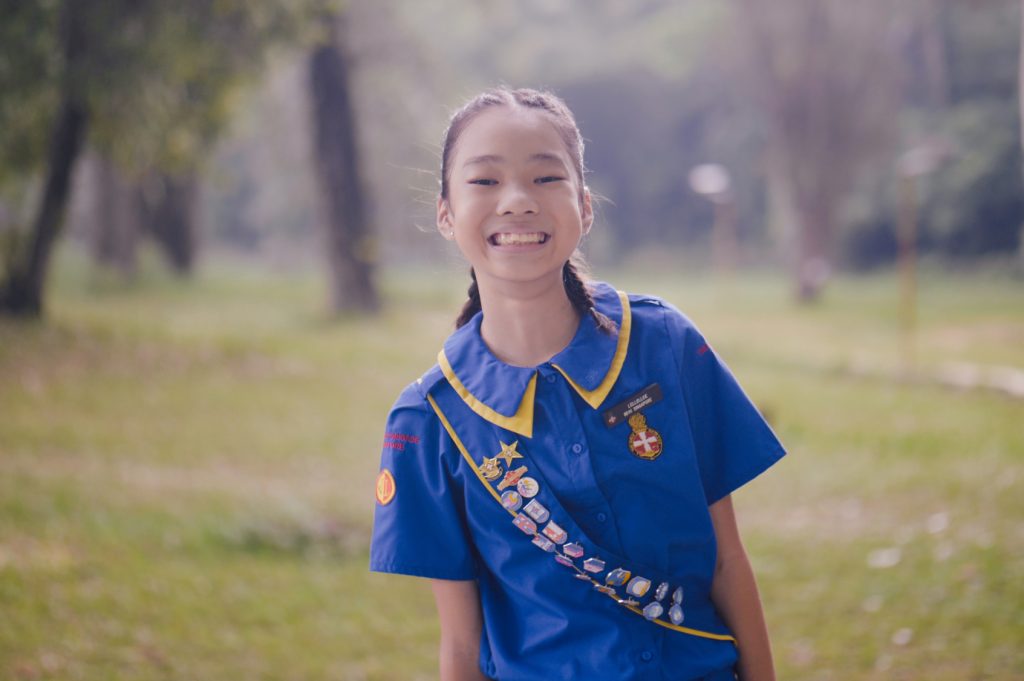 Junior Girl from The Girls’ Brigade Singapore smiling outdoors in uniform
